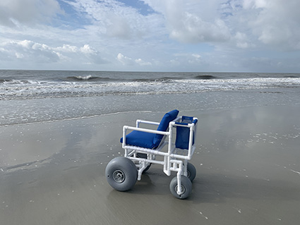 Beach Wheelchair on the beach at the edge of the water