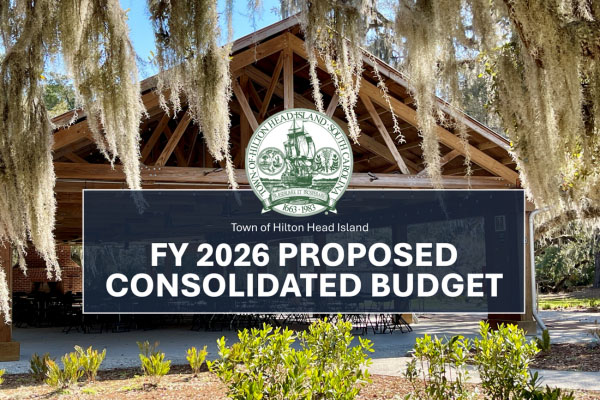 FY 2026 Proposed Consolidated Bugdet text and Town logo overlayed on photo of wooden pavilion view through oaks.