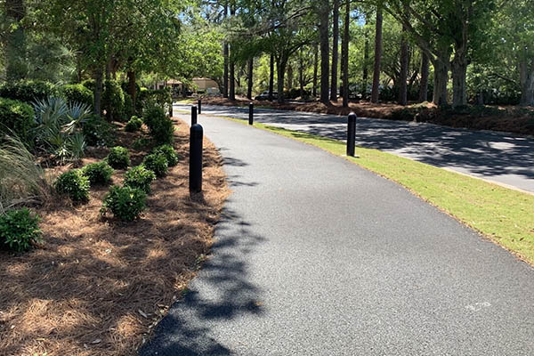 new asphalt pathway parallel to road with landschaping