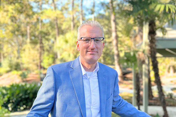 Zac Gordon outside with trees and path in background