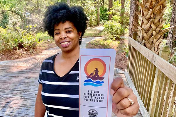 Sheryse DuBose holding brochure for new Permitting and Design Studio