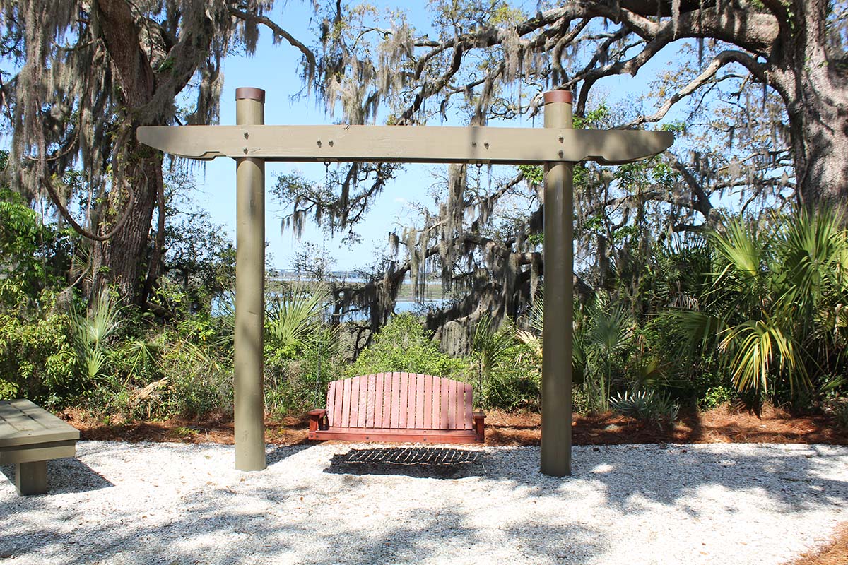 Swing with water in tress in the background