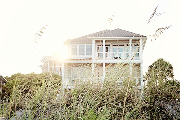 View of House with sun behind through sea otas